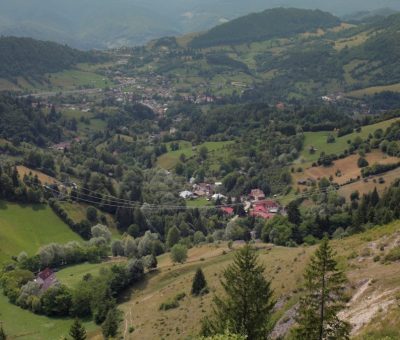 A scenic view of a valley and mountains